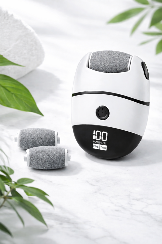 White and black electronic callus removal device with gray attachments on a light background